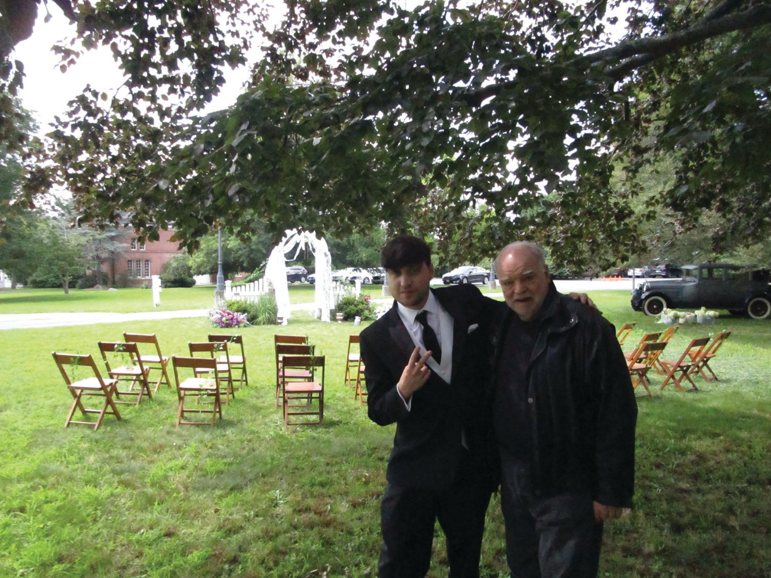 PAUL AND PAUL: Adam Carbone, who plays the title character in “Poor Paul,” shares a moment with veteran actor Richard Riehle, who plays Grandpa Paul, ahead of the wedding scene shoot outside the Sprague Mansion on Saturday.